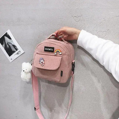 Pink mini backpack Stevvex with front pocket patches and plush white bear keychain on Tampa Home & Garden Store