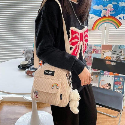 Stevvex mini beige corduroy backpack with rainbow patch and plush keychain on strap on Tampa Home & Garden Store