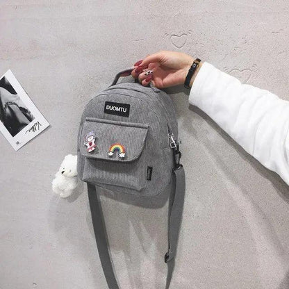 Mini gray backpack with DUOMTU patch, front pocket patches rainbow and panda, straps on Tampa Home & Garden Store