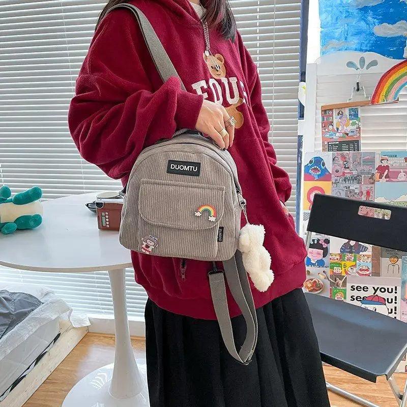 Backpack DUOMTU small gray corduroy bag with front pocket rainbow patch and plush keychain on Tampa Home & Garden Store