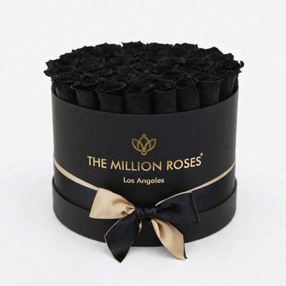 Supreme Black Box with black roses in a cylindrical gift box, gold The Million Roses logo on Tampa Home & Garden Store