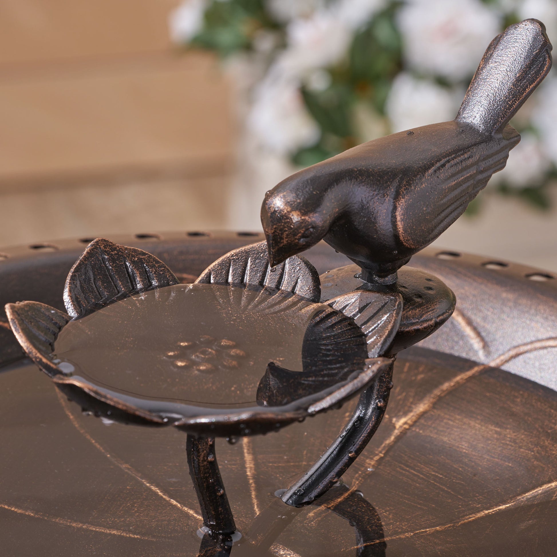 Outdoor bird bath with aluminum and iron construction and bronze finish, perched bird detail on Tampa Home & Garden Store