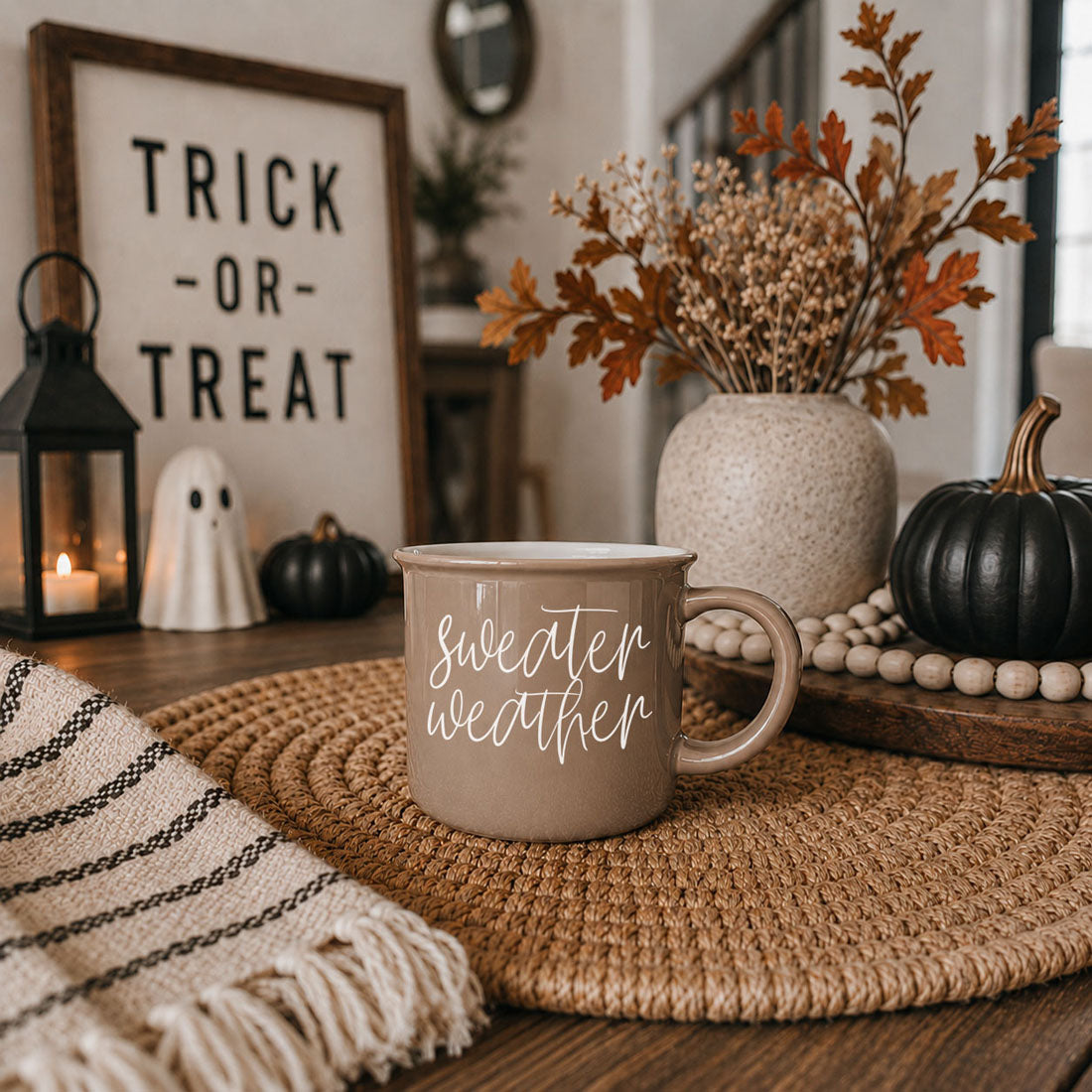 Mug Sweater Weather ceramic taupe mug with white script on woven placemat on Tampa Home & Garden Store