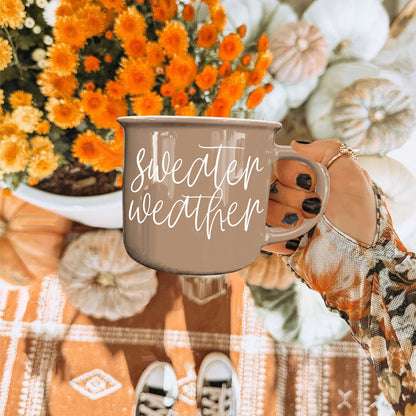 Gia Roma Sweater Weather coffee mug in taupe with white script, hand-held on Tampa Home & Garden Store