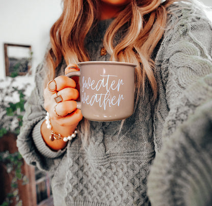 Sweater Weather mug by Gia Roma in beige with white script held in a gray knit sweater on Tampa Home & Garden Store
