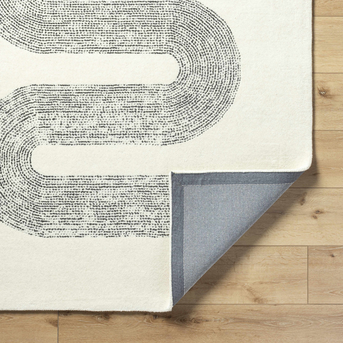Saura Wool Area Rug Boutique Rugs in ivory with dark dotted pattern; several rug swatches on Tampa Home & Garden Store