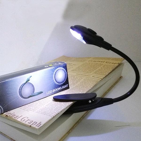 Table lamp by Stevvex with black flexible gooseneck and clip base beside LED Booklight box on Tampa Home & Garden Store