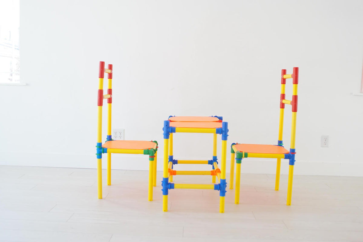 TubeLox Deluxe Set: 2 chairs and a table in bright yellow, red, blue, and orange tubes on Tampa Home & Garden Store