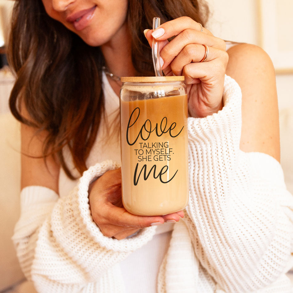 Love Me 20oz Gia Roma glass cup with lid and straw, filled with light brown iced coffee on Tampa Home & Garden Store