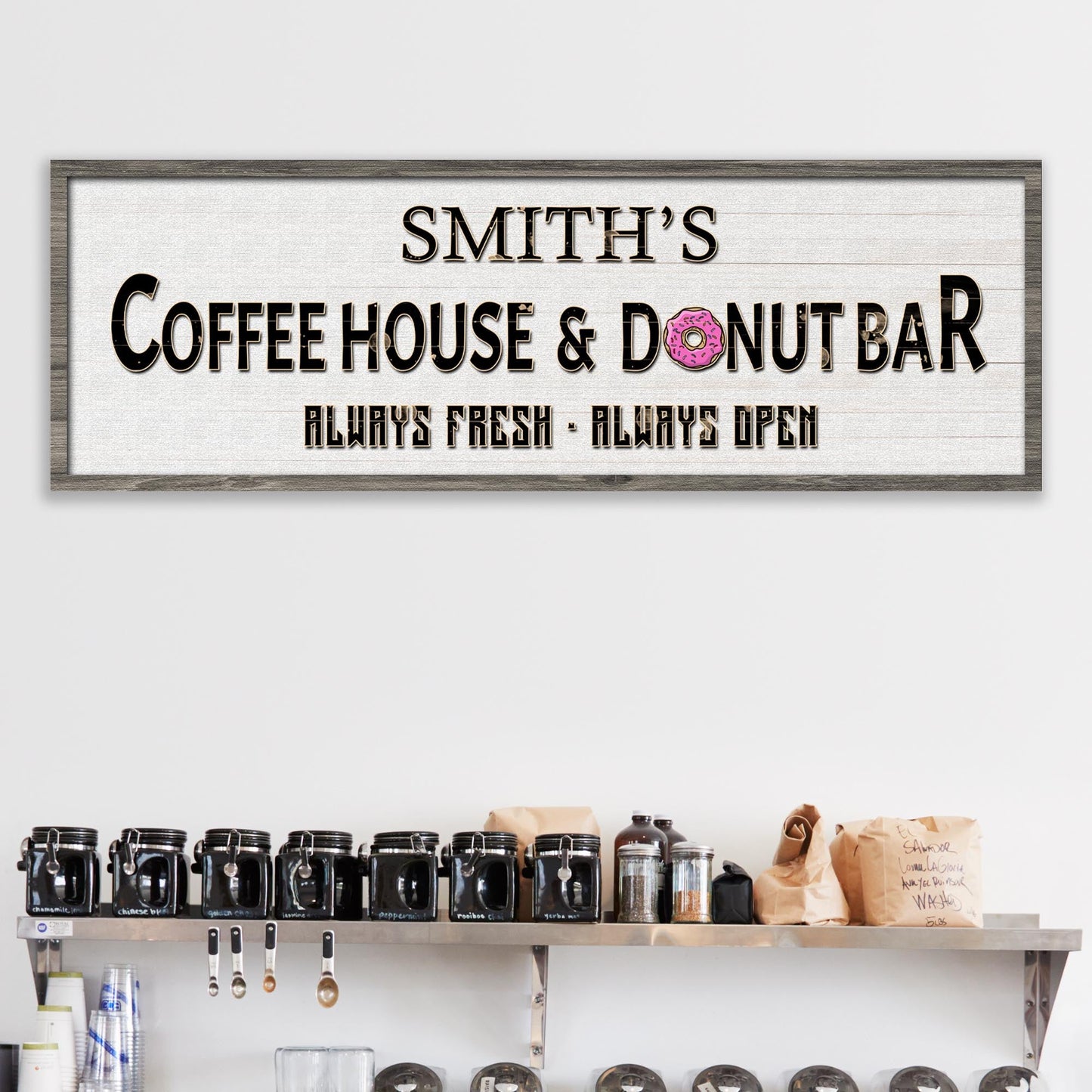 Canvas sign Coffee House & Donut Bar with black lettering and pink donut icon on wood frame on Tampa Home & Garden Store