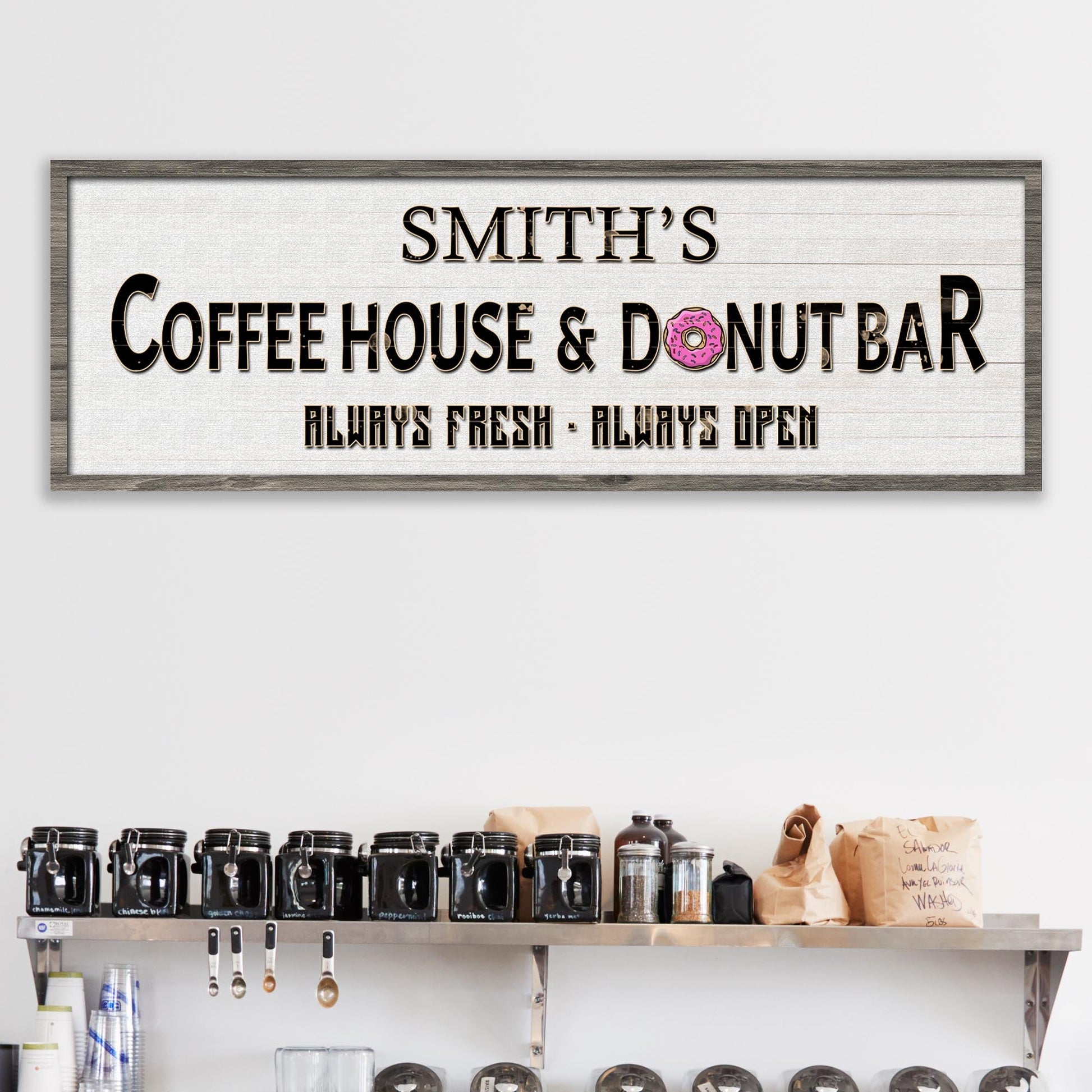 Canvas sign Coffee House & Donut Bar with black lettering and pink donut icon on wood frame on Tampa Home & Garden Store