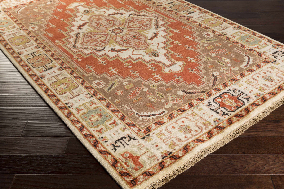 Texico Area Rug by Boutique Rugs in rust and cream with medallion and fringed edges on Tampa Home & Garden Store