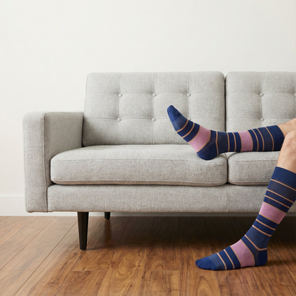 The Blues Dress Sock Bundle DeadSoxy boardroom socks in blue pink tan stripes worn on a sofa on Tampa Home & Garden Store