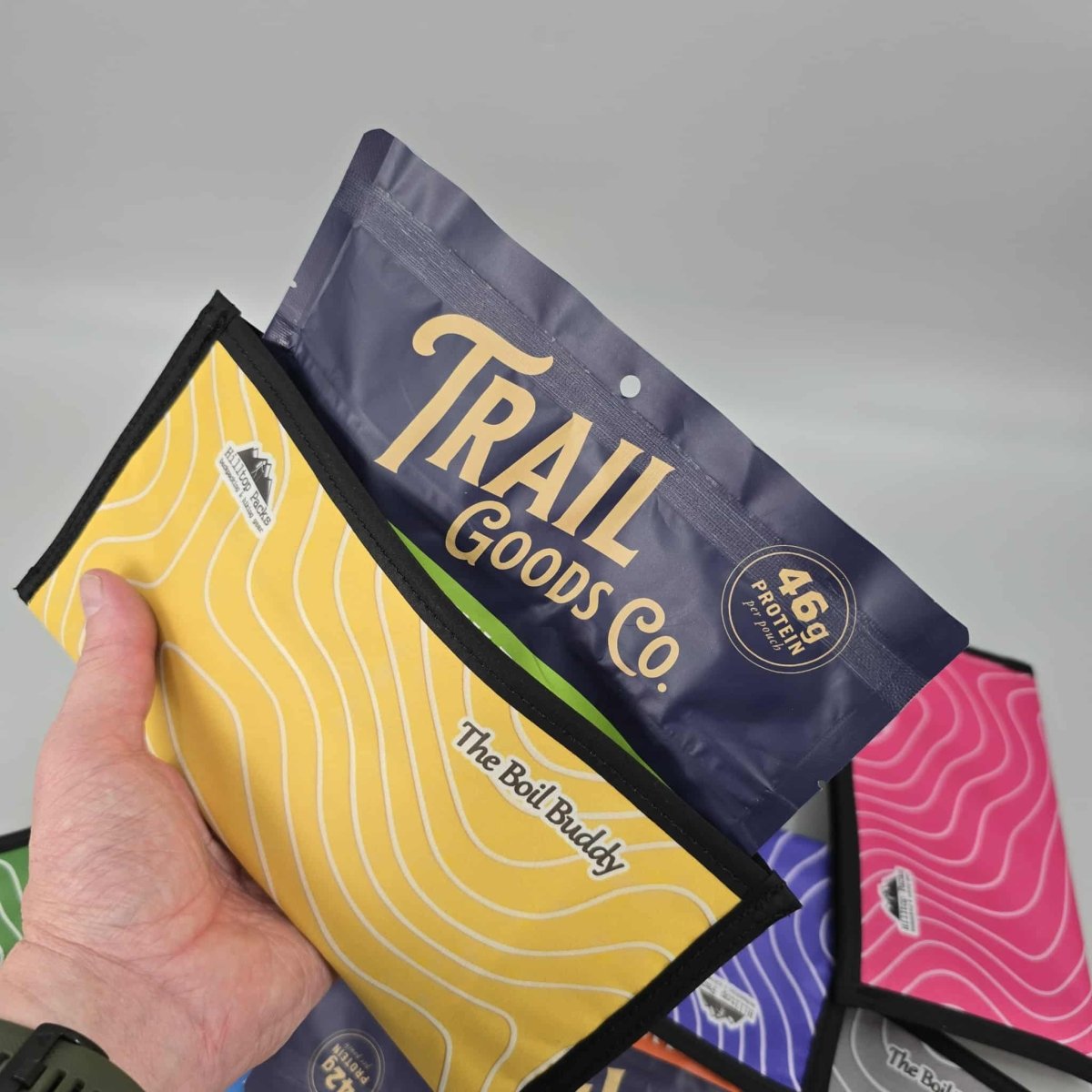 The Boil Buddy Ultralight Insulated Food Pouch yellow with black trim, assorted colors visible on Tampa Home & Garden Store