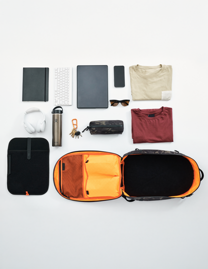 Conceal Pack 21L backpack, black exterior with orange interior, open with organized gear on Tampa Home & Garden Store