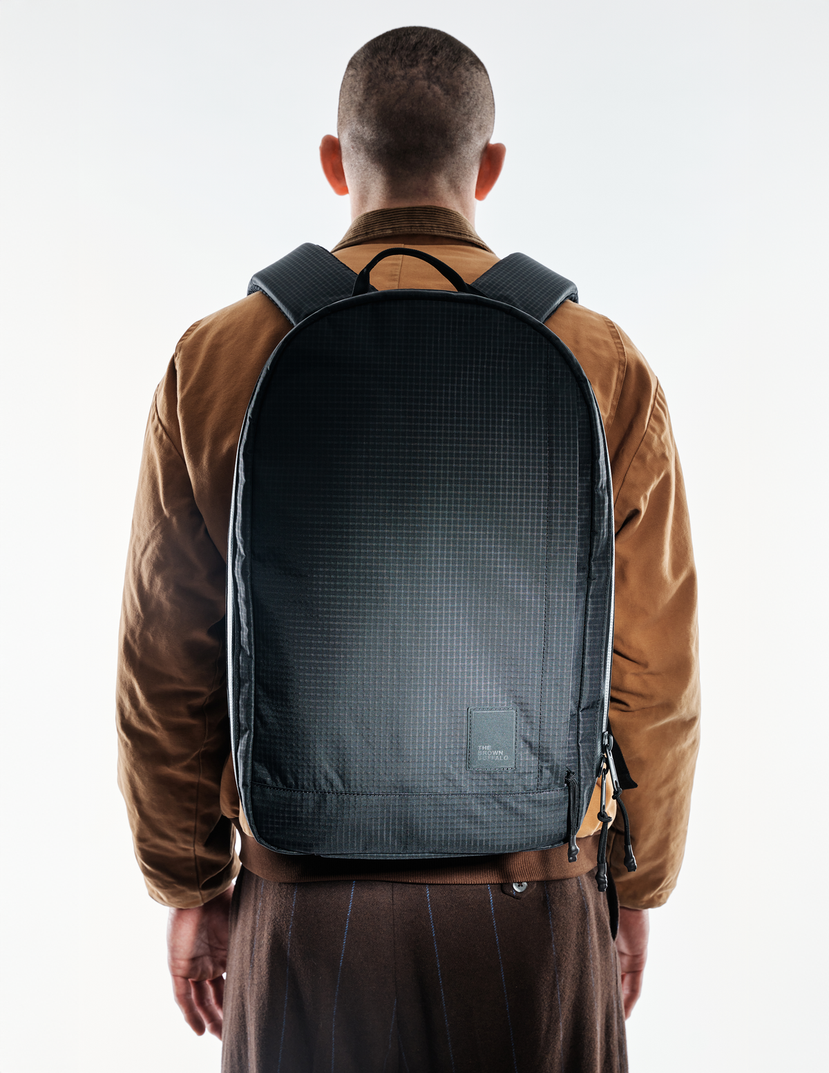 Conceal Pack 21L backpack black grid fabric with The Brown Buffalo label back view on Tampa Home & Garden Store