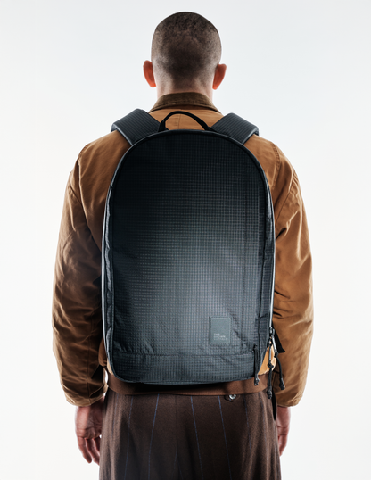 Conceal Pack 21L backpack black grid fabric with The Brown Buffalo label back view on Tampa Home & Garden Store