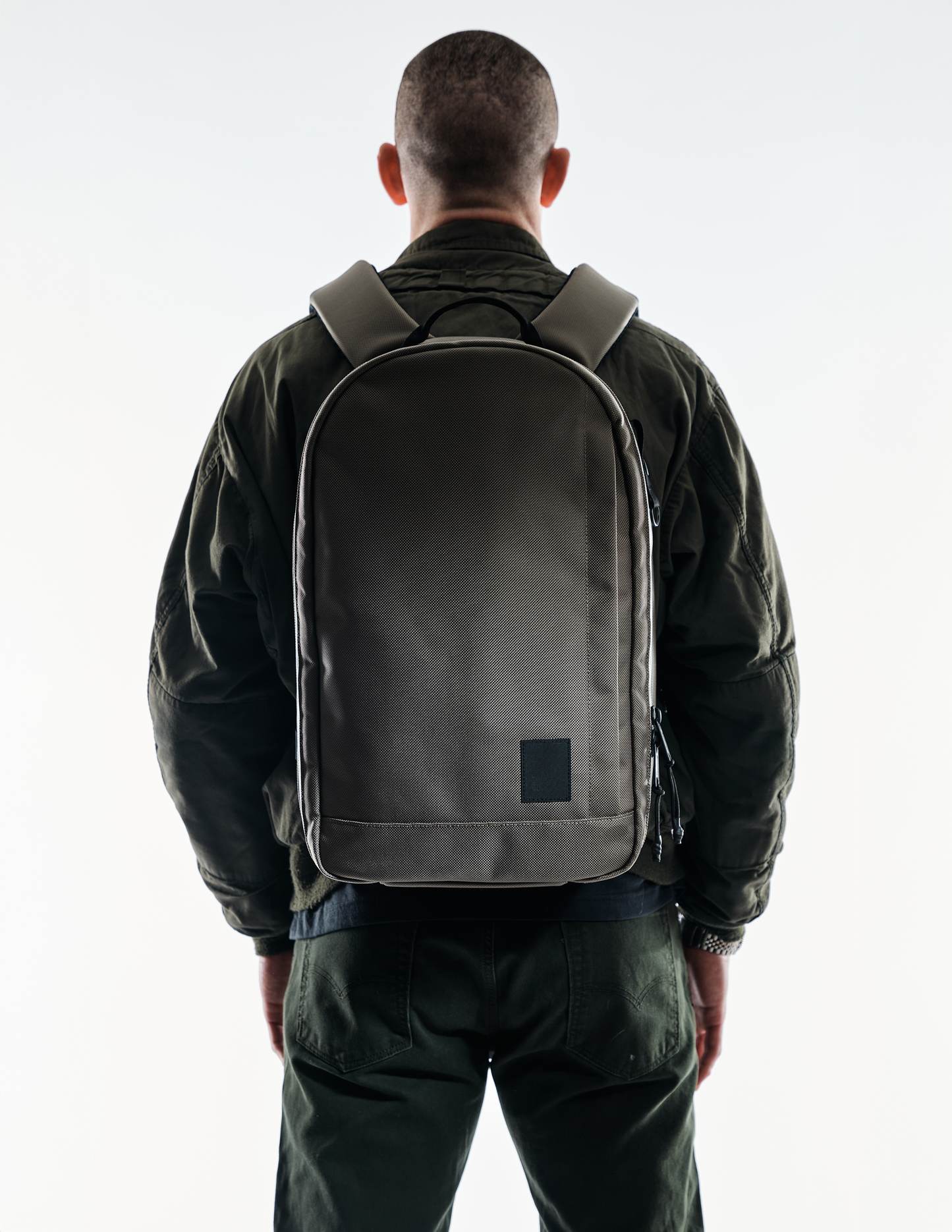 Conceal Pack 21L backpack by The Brown Buffalo in olive-brown fabric, back view on Tampa Home & Garden Store