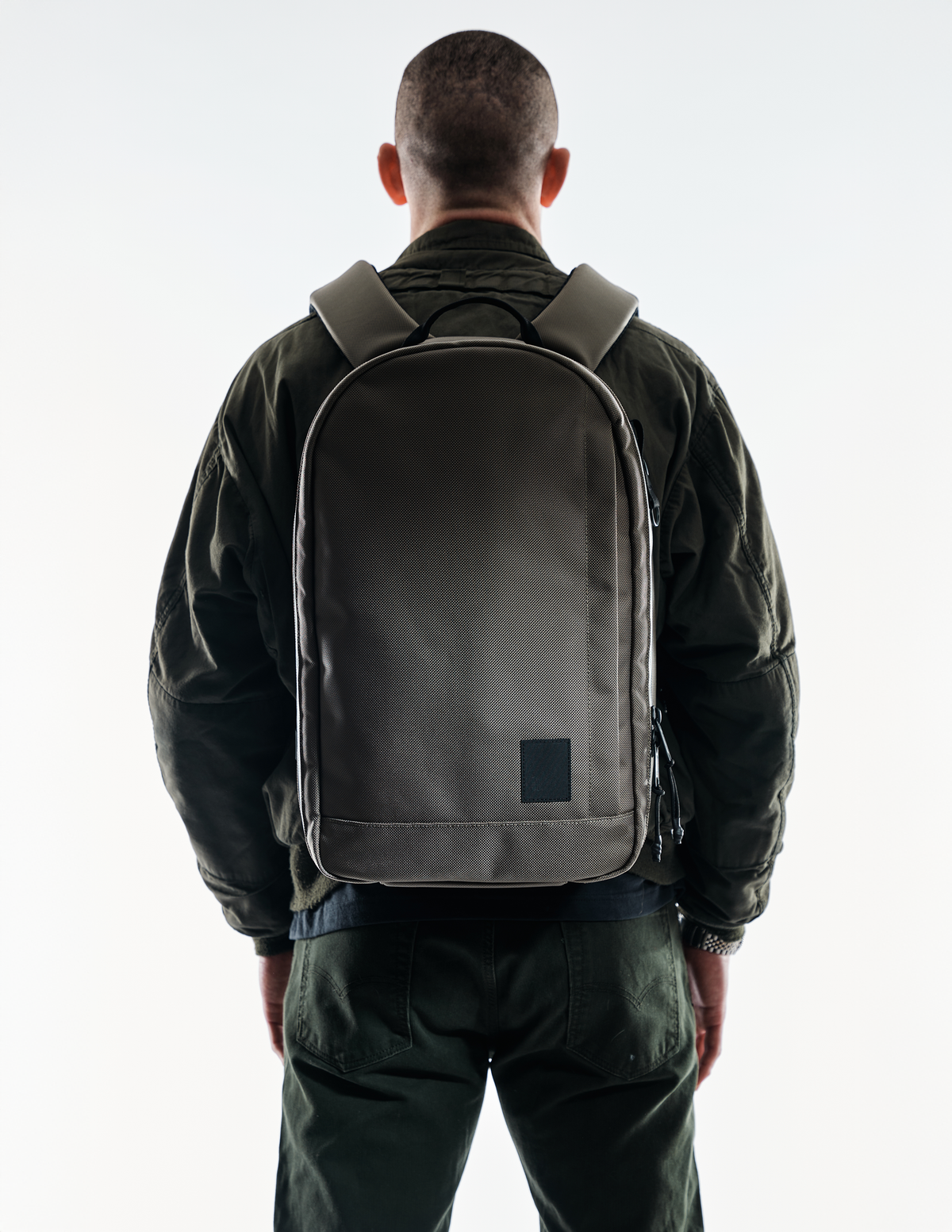 Conceal Pack 21L backpack by The Brown Buffalo in olive-brown fabric, back view on Tampa Home & Garden Store