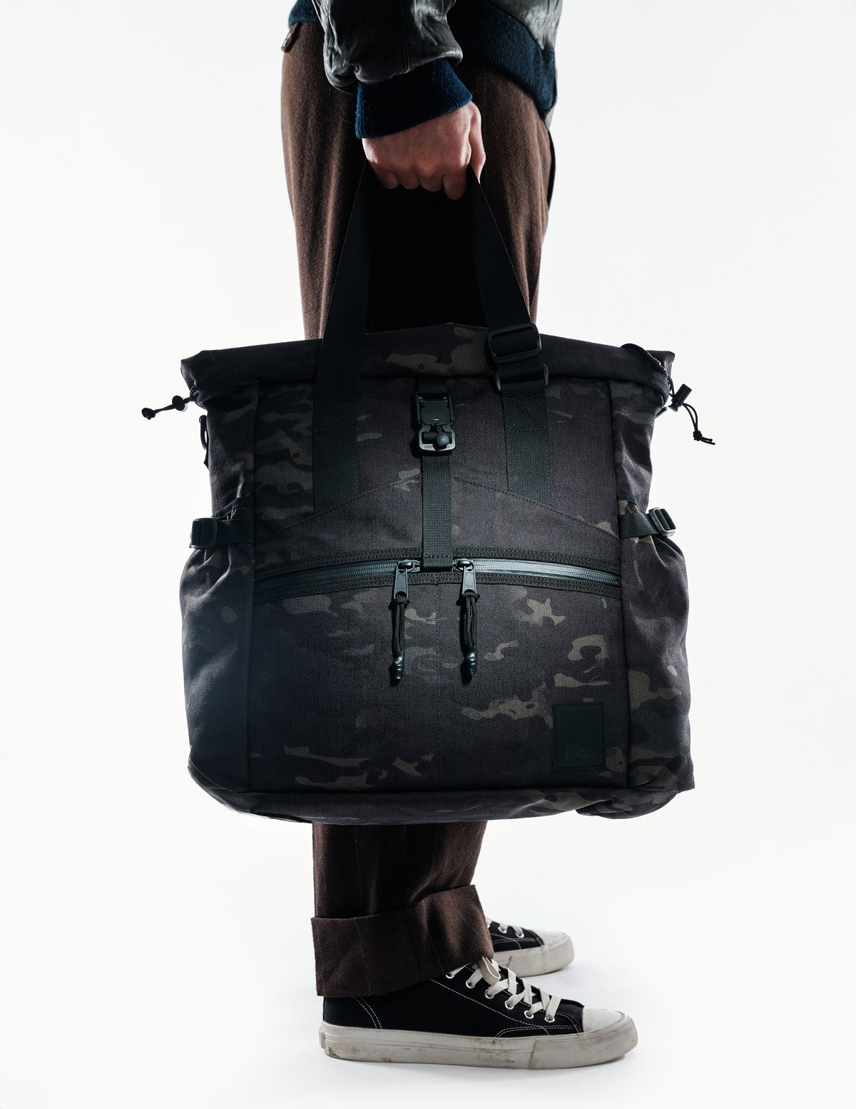 Conceal Tote camouflage tote bag by The Brown Buffalo with black straps held by hand on Tampa Home & Garden Store