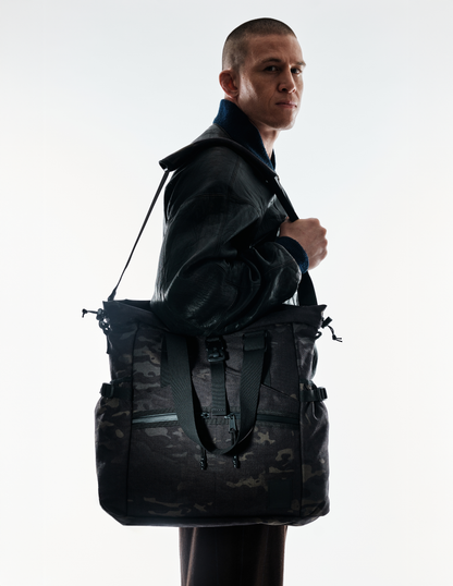 Conceal Tote by The Brown Buffalo, black camouflage tactical tote with shoulder strap on model on Tampa Home & Garden Store