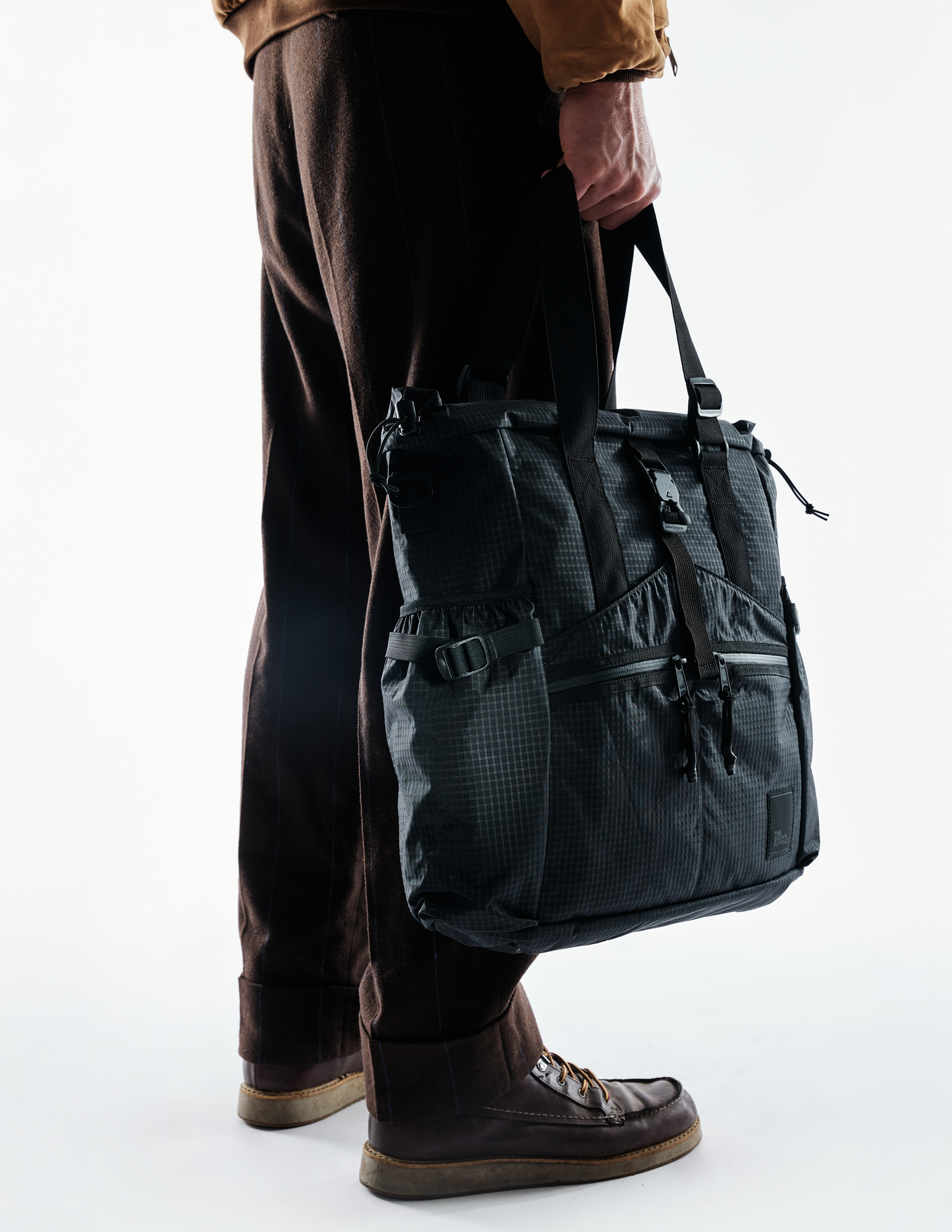 Conceal Tote The Brown Buffalo, dark gray tactical tote with buckles on Tampa Home & Garden Store