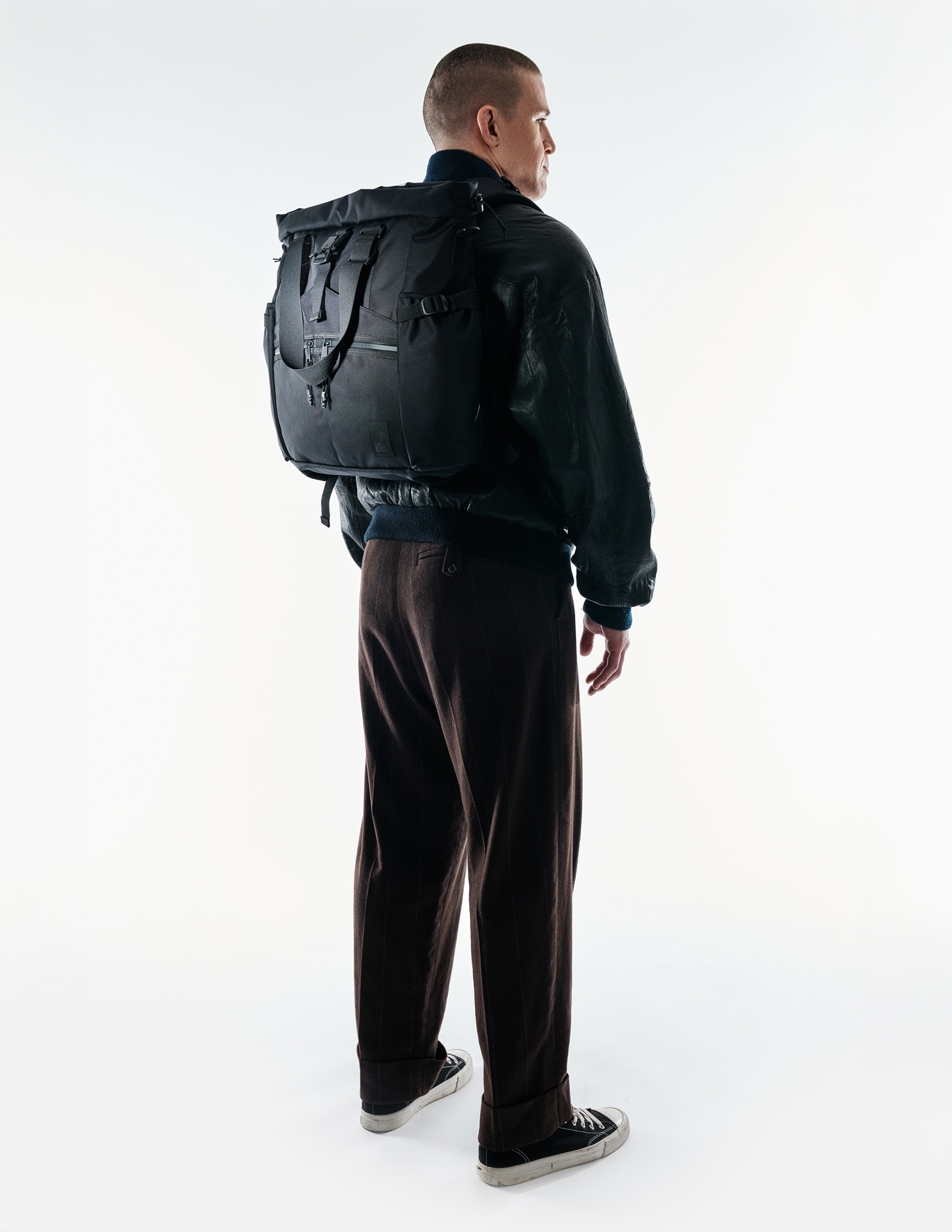 Conceal Tote by The Brown Buffalo, black tote bag with multiple straps, worn as backpack on Tampa Home & Garden Store