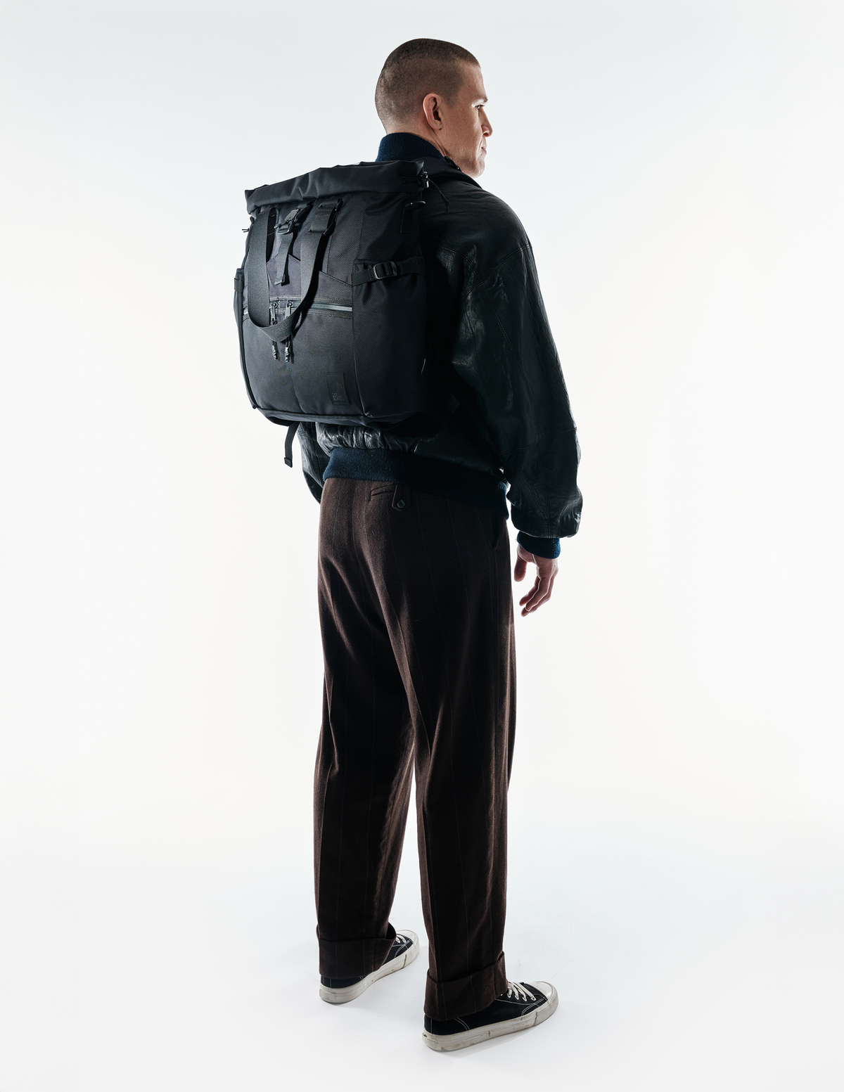 Conceal Tote by The Brown Buffalo, black tote bag with multiple straps, worn as backpack on Tampa Home & Garden Store