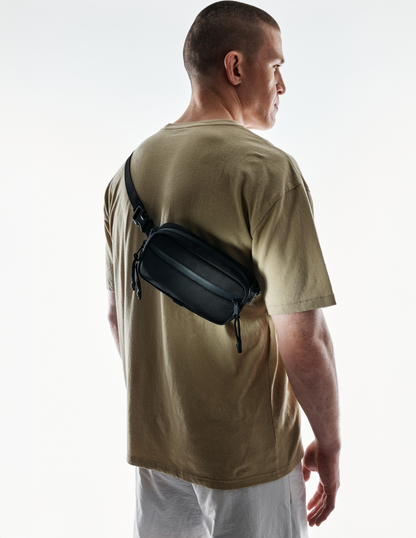 Conceal Waistpack by The Brown Buffalo in black nylon, worn across back with adjustable strap on Tampa Home & Garden Store