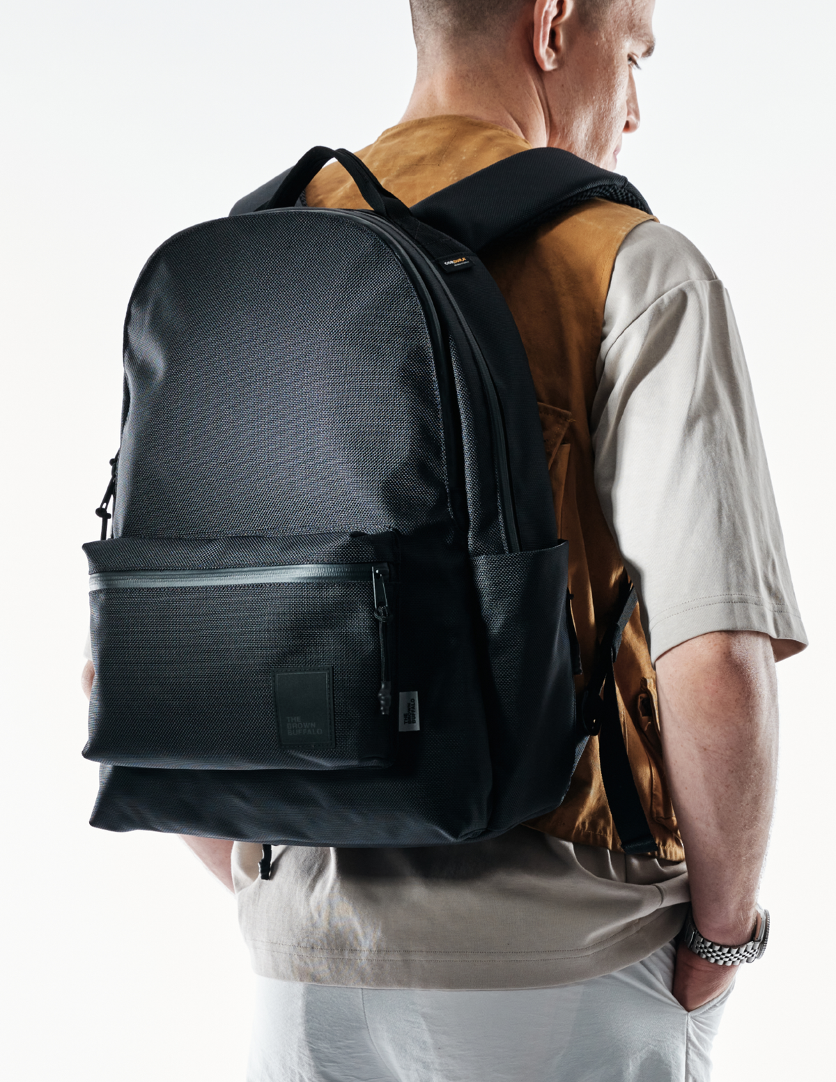 Backpack The Brown Buffalo Standard Issue in black textured fabric with front zip pocket on Tampa Home & Garden Store