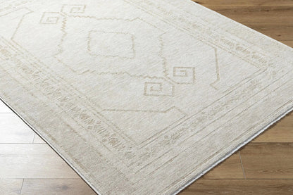 Taban Luxe Rug beige geometric border with square motifs on light wood floor on Tampa Home & Garden Store