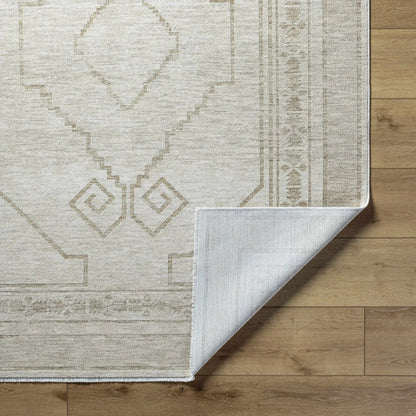 Taban Luxe Rug neutral beige with geometric diamond border on wood floor on Tampa Home & Garden Store