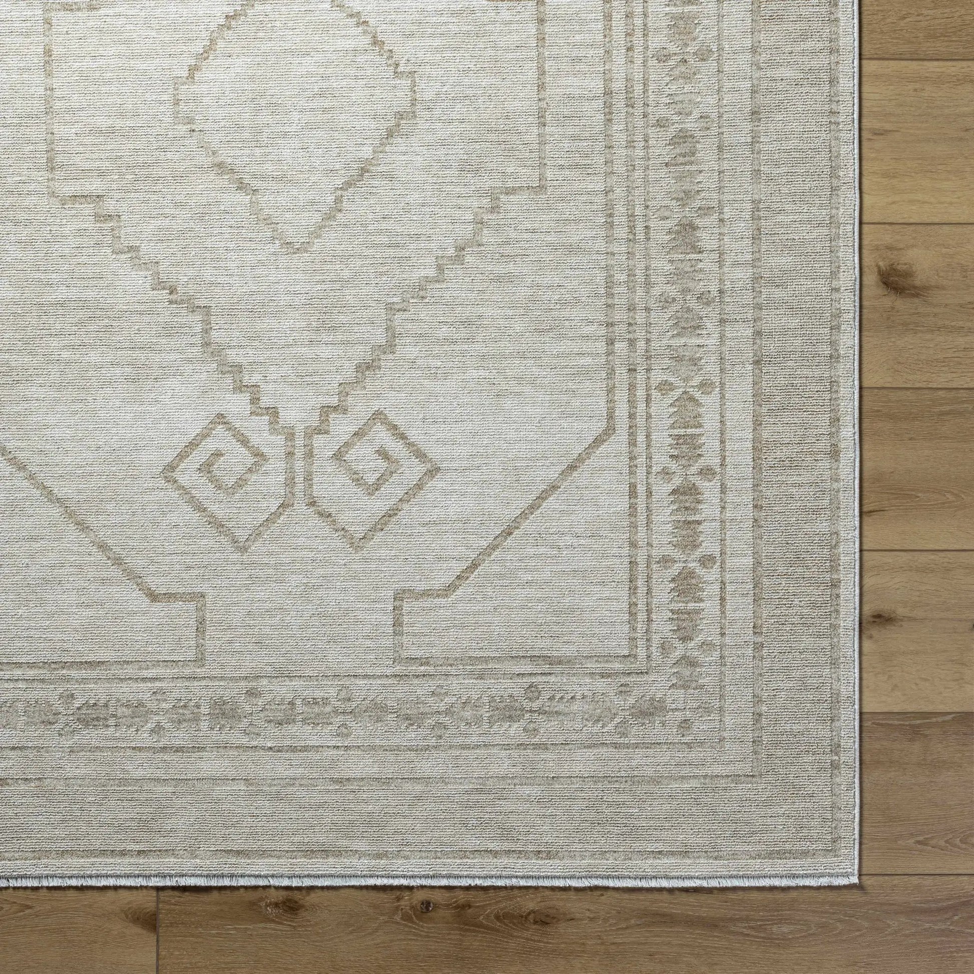 Taban Luxe Rug by Boutique Rugs, beige geometric medallion with bordered edges on wood floor on Tampa Home & Garden Store