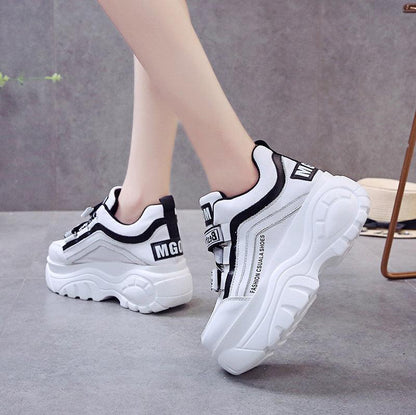 Pair of white chunky sneakers with black trim and side stripe casual fashion footwear on Tampa Home & Garden Store