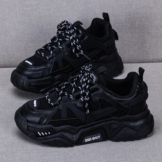 Stevvex black chunky sneakers pair shown with mesh panels, speckled laces, thick platform sole on Tampa Home & Garden Store