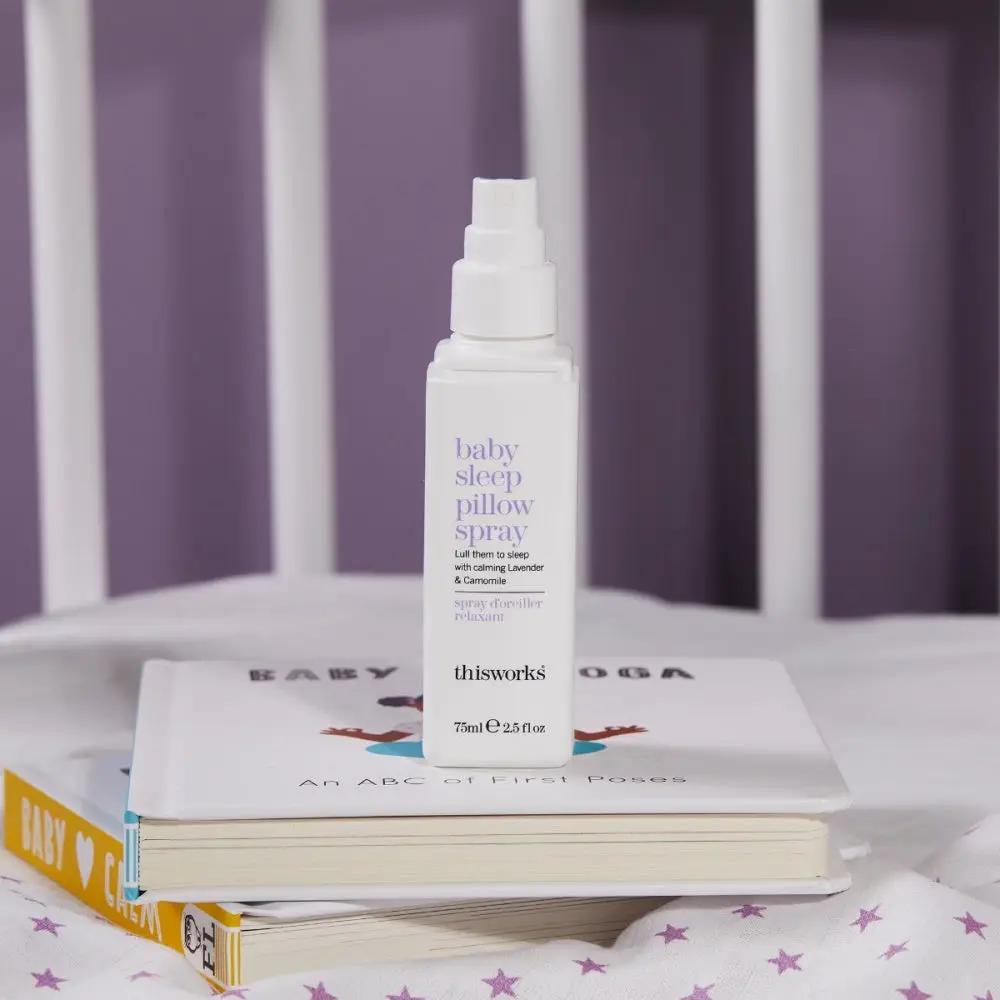 This Works Baby Sleep Pillow Spray bottle, white with lavender label, 75ml, atop baby books on Tampa Home & Garden Store
