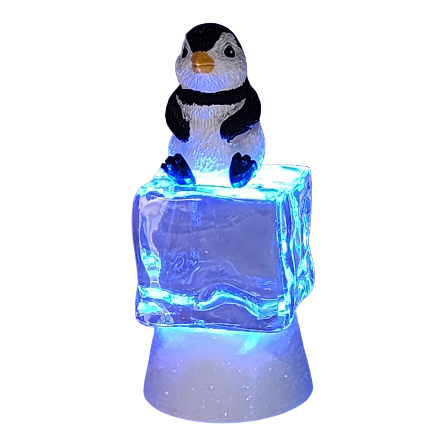 Penguin figurine sitting on a color-changing lighted ice cube with blue glow on Tampa Home & Garden Store