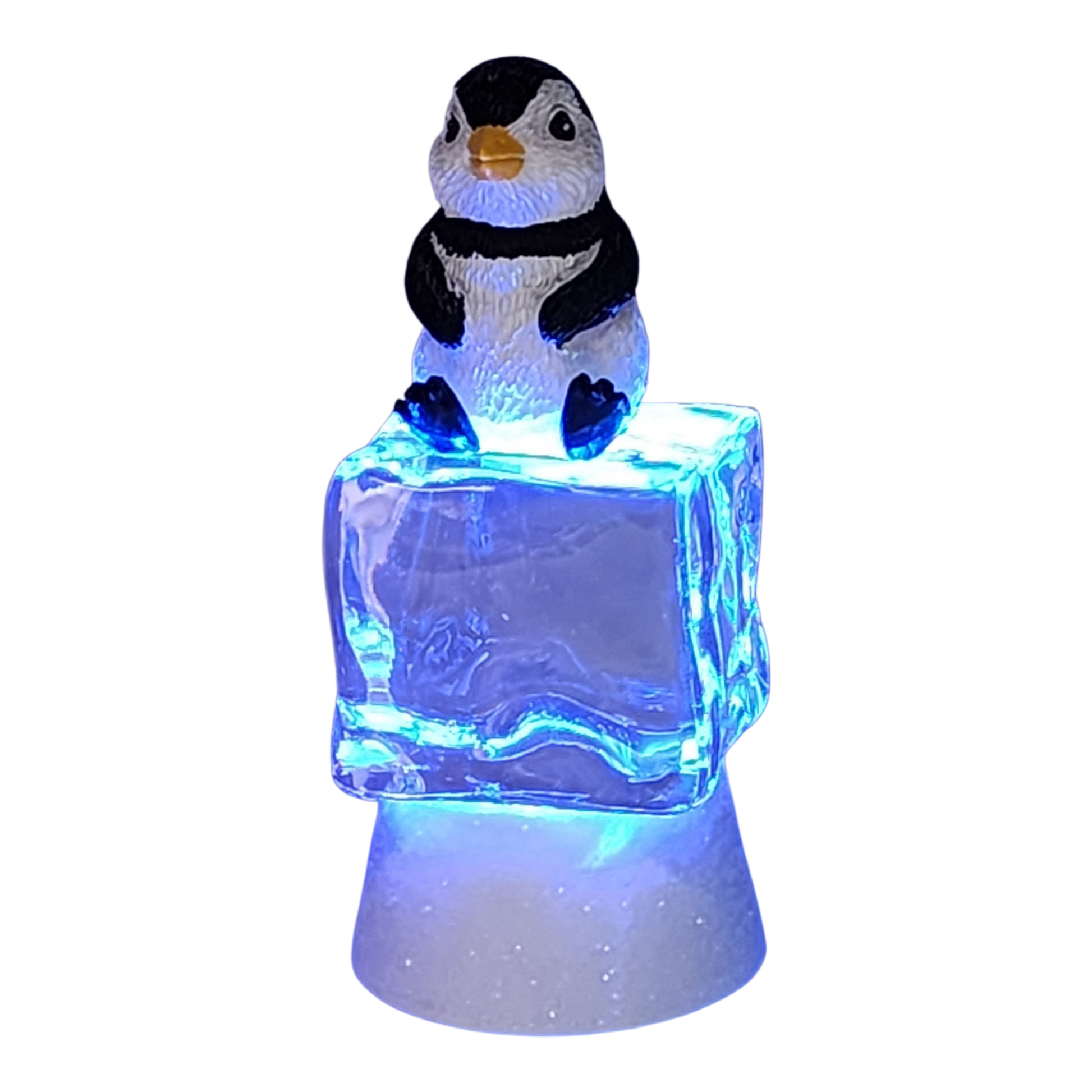 Penguin figurine sitting on a color-changing lighted ice cube with blue glow on Tampa Home & Garden Store