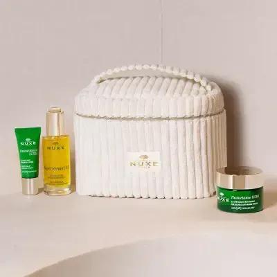 3-piece Nuxe Nuxuriance Ultra eye cream set: green tube, gold bottle, green jar beside bag on Tampa Home & Garden Store