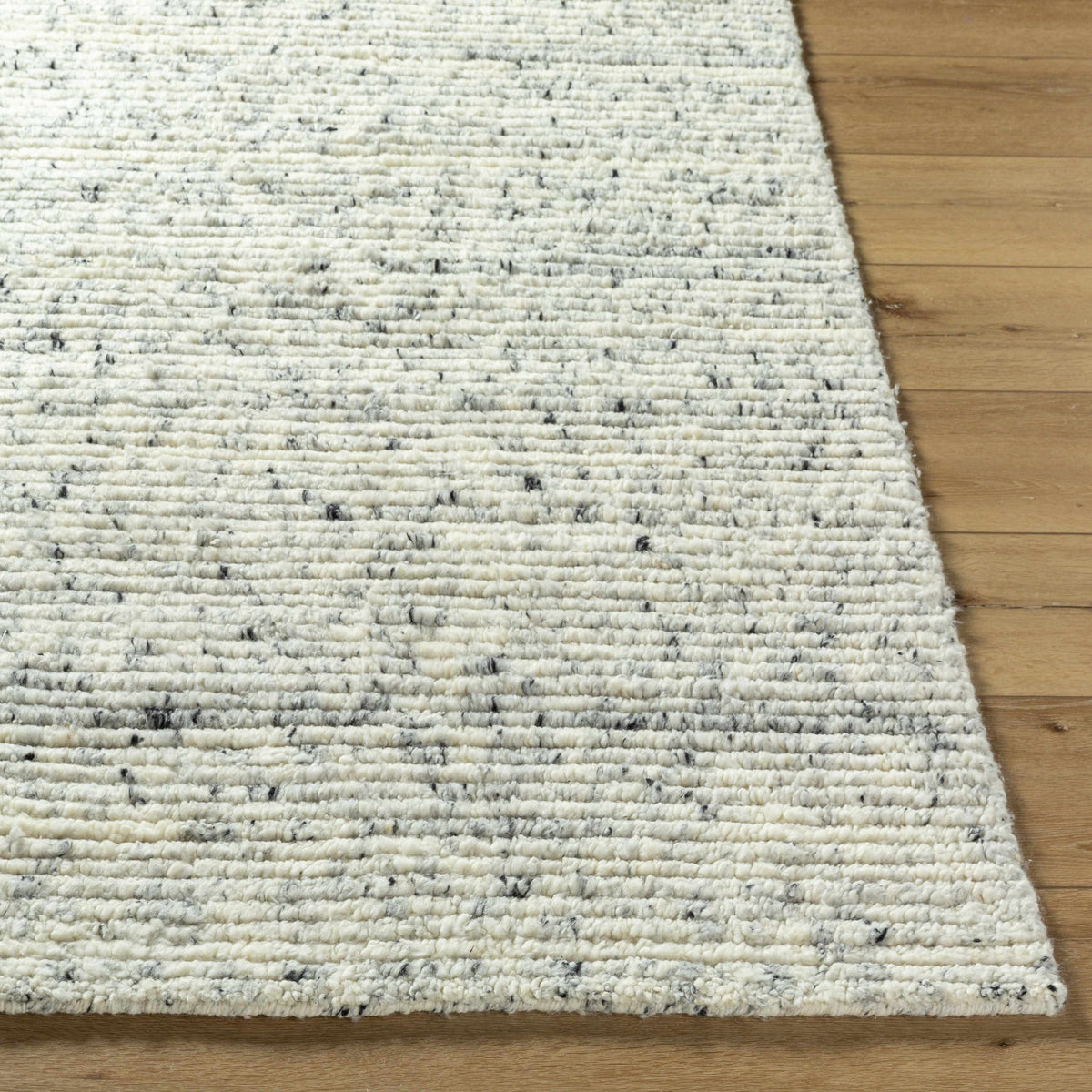 Torie Green NZ Wool Area Rug by Boutique Rugs in cream with flecks, plush weave on wood floor on Tampa Home & Garden Store