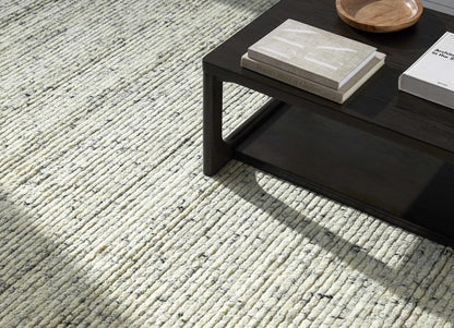 Torie Green NZ Wool Area Rug by Boutique Rugs in cream loop pile beside a dark wood coffee table on Tampa Home & Garden Store