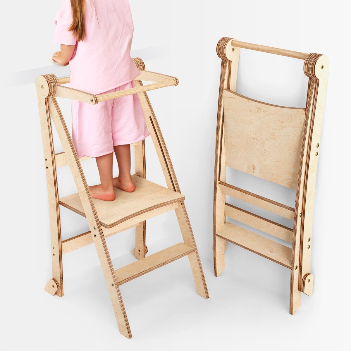 Toddler Tower foldable step stool natural beige wood; child stands on top, folded version shown beside it on Tampa Home & Garden Store