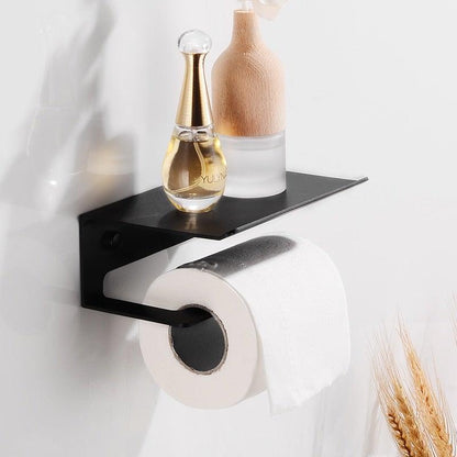 Black metal wall-mounted toilet paper holder with shelf and roll on Tampa Home & Garden Store