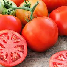 Tomato seeds Delicious Tomato Seedtime Store red tomatoes with sliced halves on wood on Tampa Home & Garden Store