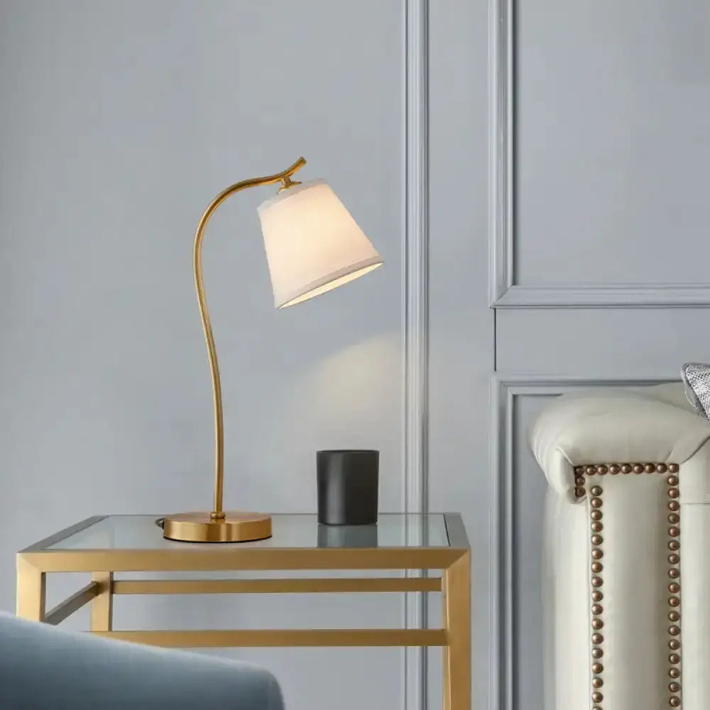 Traditional bucket brass table lamp with white shade on a glass gold table Decorbites on Tampa Home & Garden Store