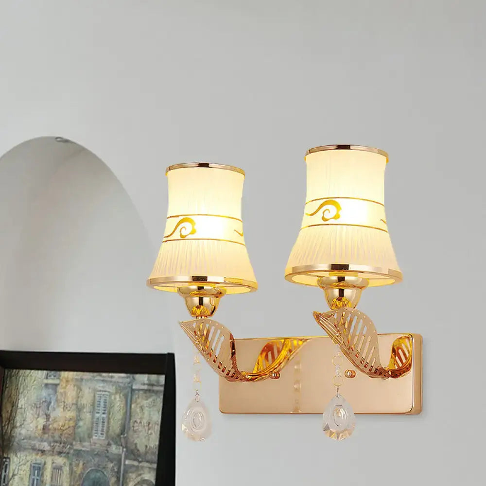 Gold crystal ribbed glass wall sconce pair with curved brass arms and dangling crystals on Tampa Home & Garden Store