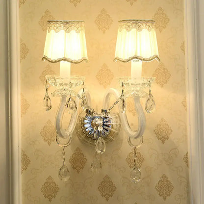 Traditional White Candle Wall Lamp with Clear Crystal Accent and Scalloped Fabric Shade