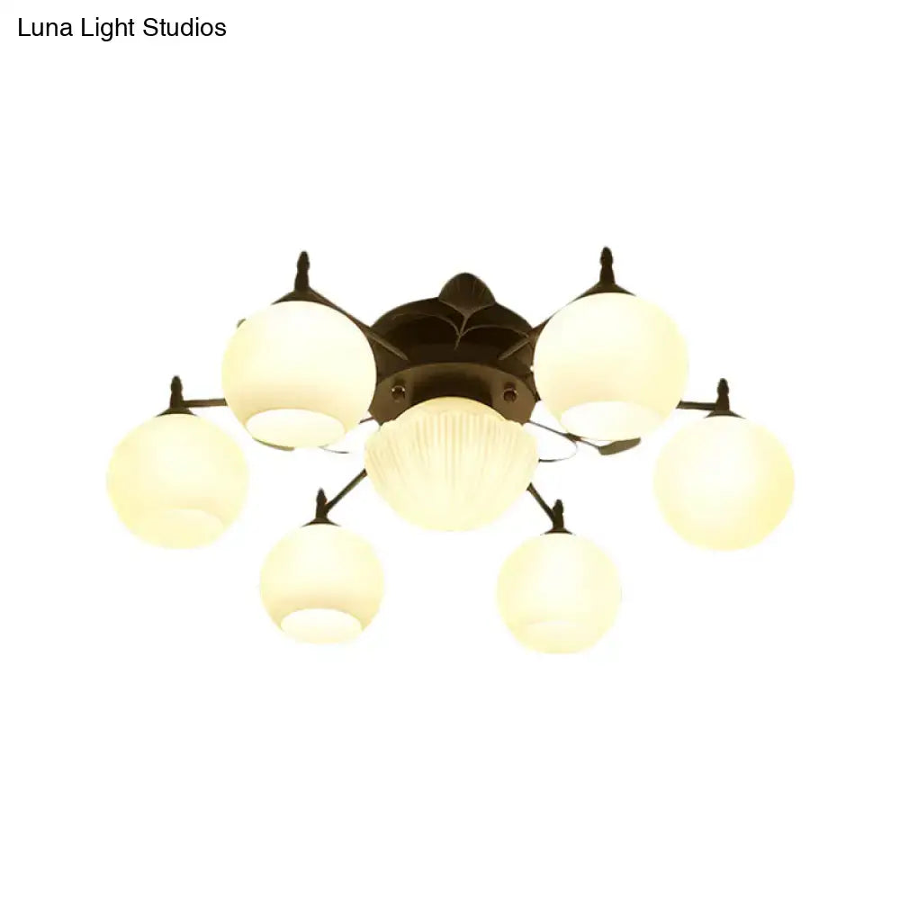 White glass bubble ceiling light with seven frosted globes on dark bronze flush mount on Tampa Home & Garden Store