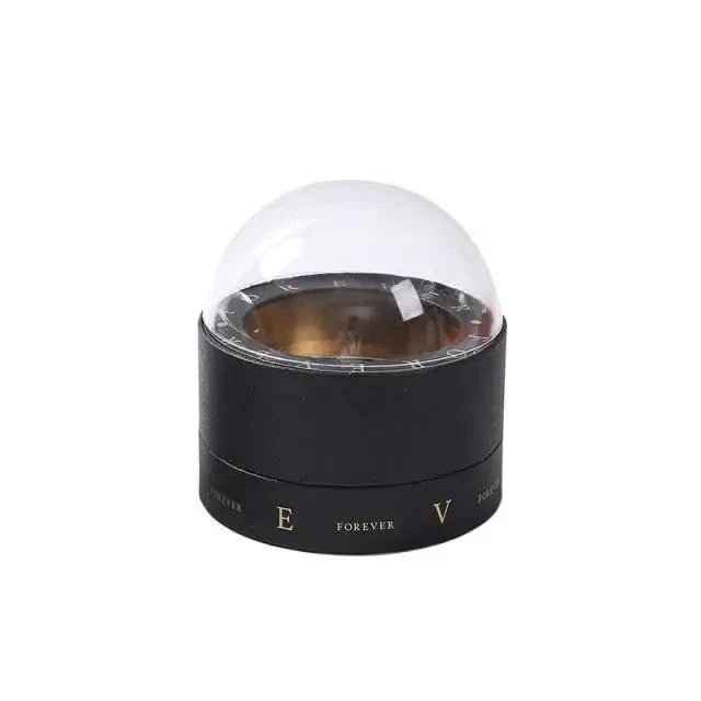 Transparent glass dome over black Stevvex chocolate gift box with gold Forever lettering on Tampa Home & Garden Store