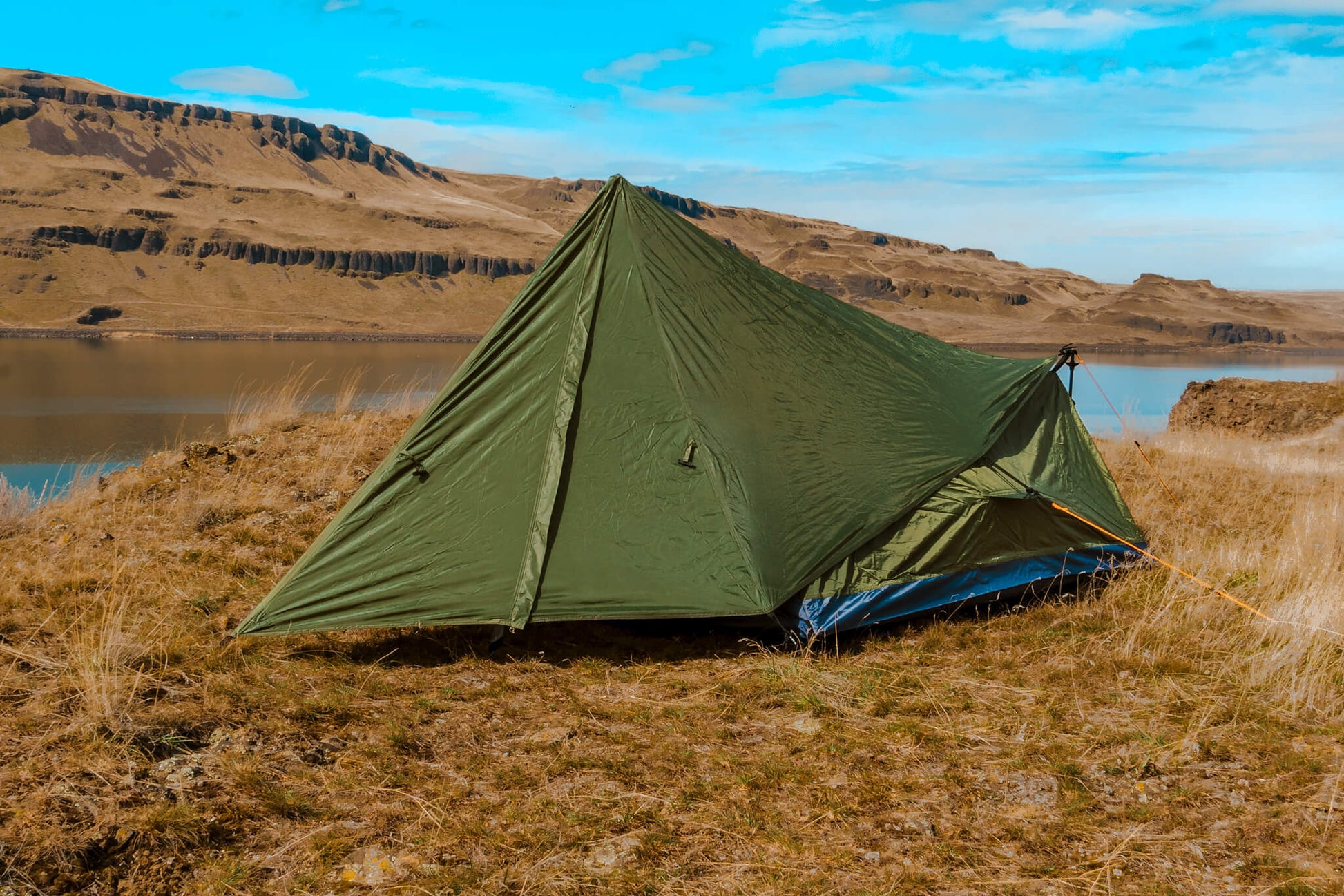 Trekker Tent 1V by River Country Gear, olive-green 1-person backpacking tent beside a lake on Tampa Home & Garden Store